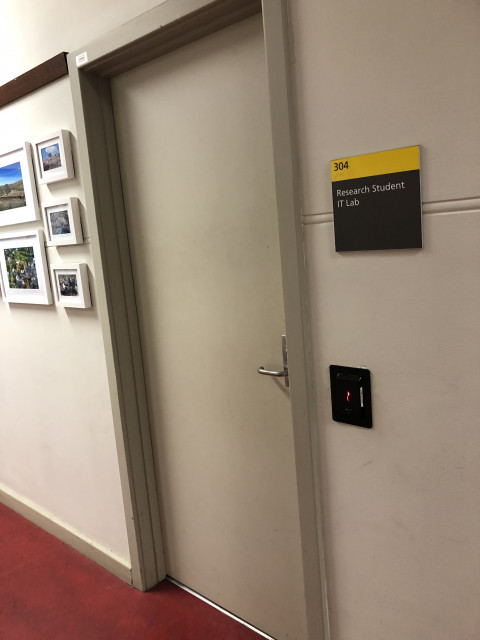On the left at southern end of the corridor