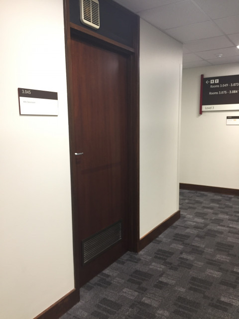 At the end of the hall, past the arts reception desk