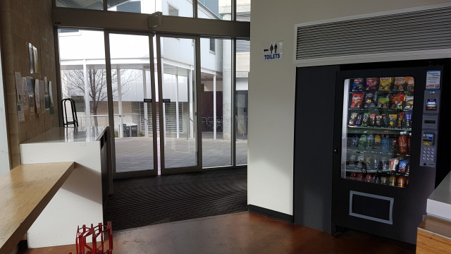 Cold beverage vending machine near east entrance.