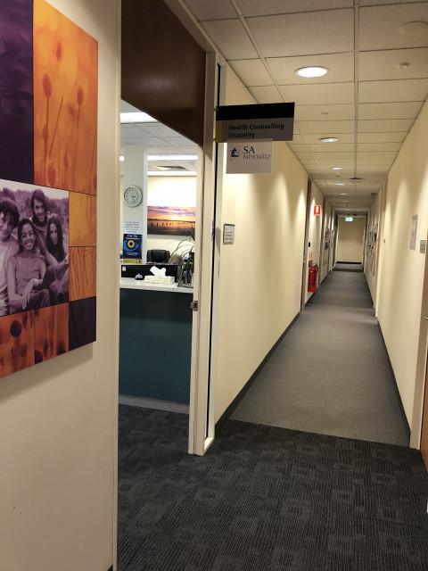 Door on left under sign