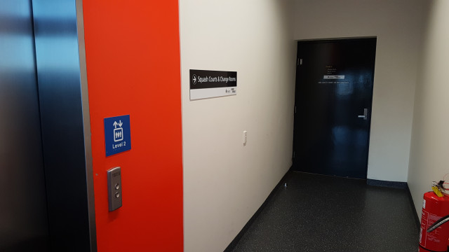 Door to change room corridor beside elevator.