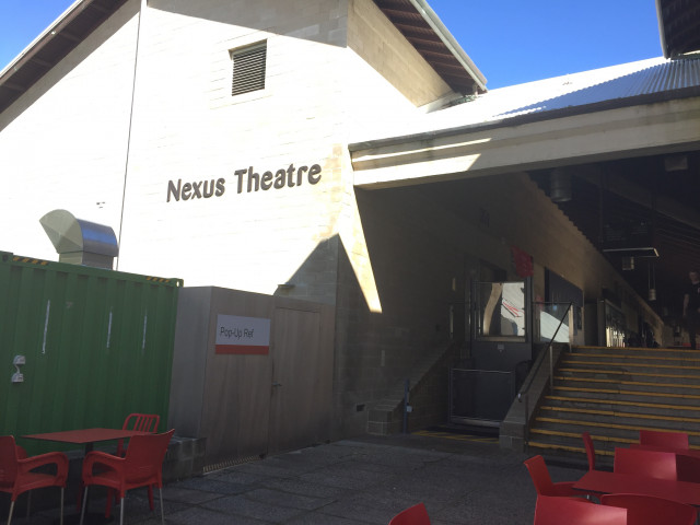 East side of the building, next to the Pop-up Ref