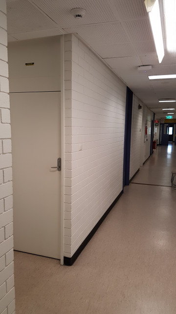 Female toilet tucked inside this hallway.