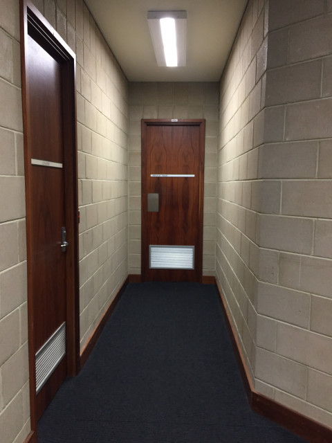 Last door in the middle.