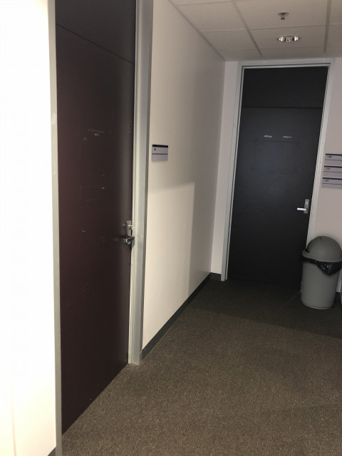 Left side at end of corridor