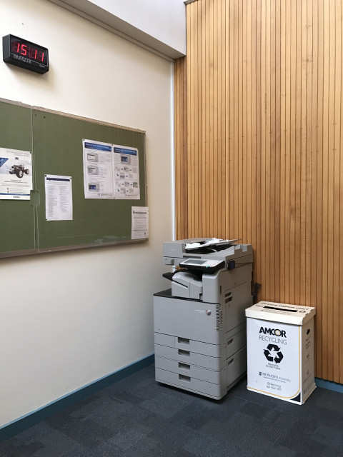 Located against wood paneling at end of main corridor, eastern end