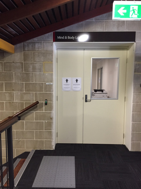 Located at the top of the stairs, on the left