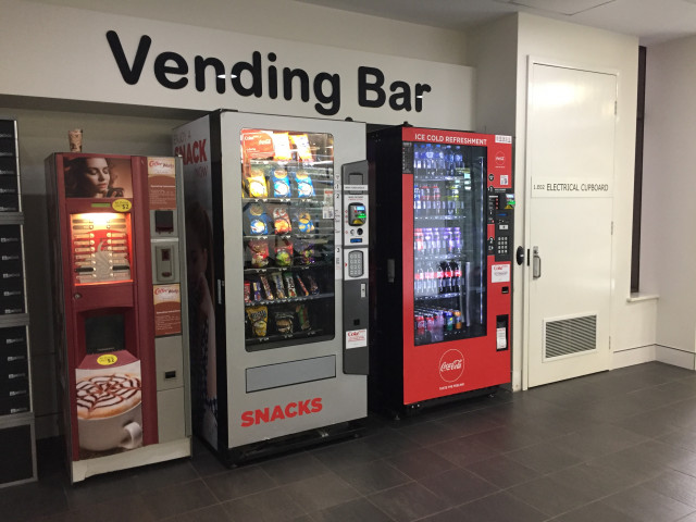 Located next to a snack and a hot drink vending machine