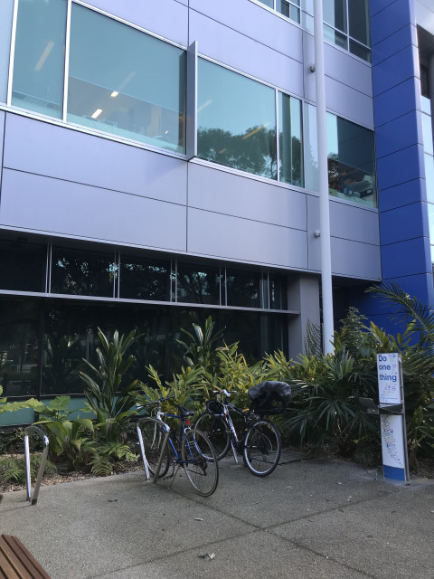 Located next to bike racks near entrance