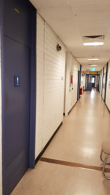 Male toilets along hallway.