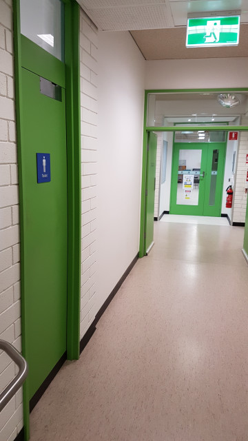 Male toilets facing the corner of the building.