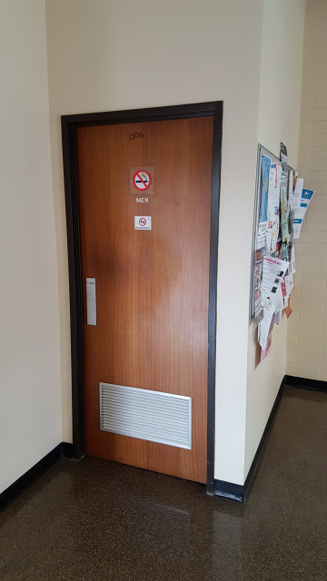 Men's level 0 toilet just inside entrance from humanities