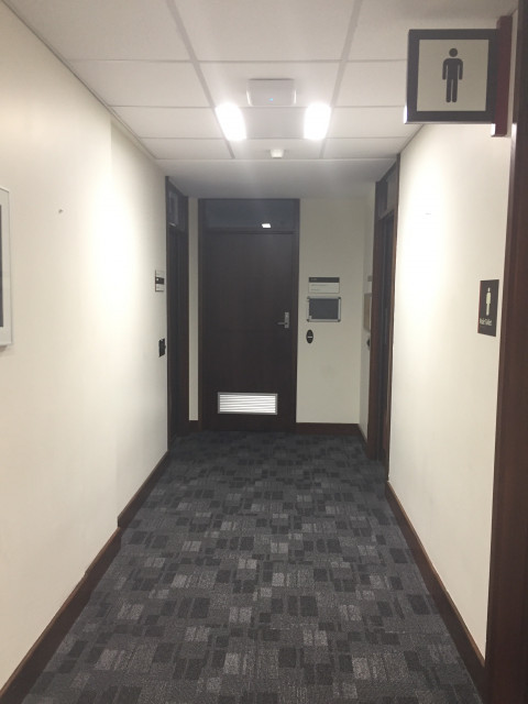 Middle door at the end of the hall.