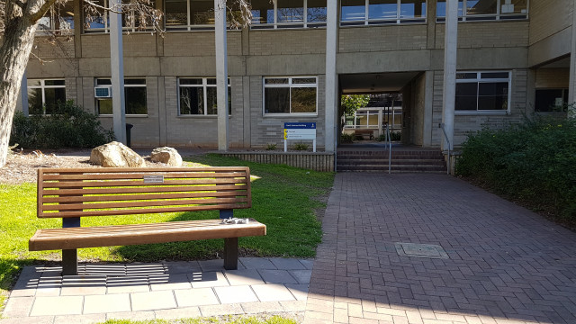 Murray McCaskill memorial bench in front of the earth sciences building.