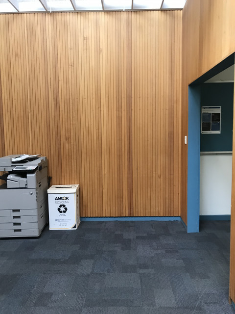 Next to door through to eastern stairs