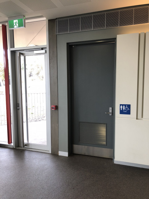 Next to red exit door
