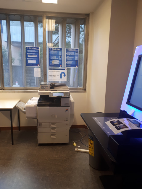 Next to the library check out desks