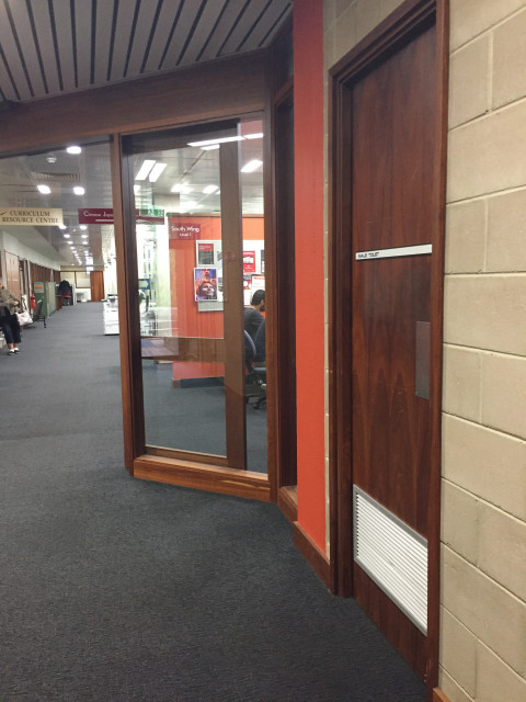 Next to the main entrance.