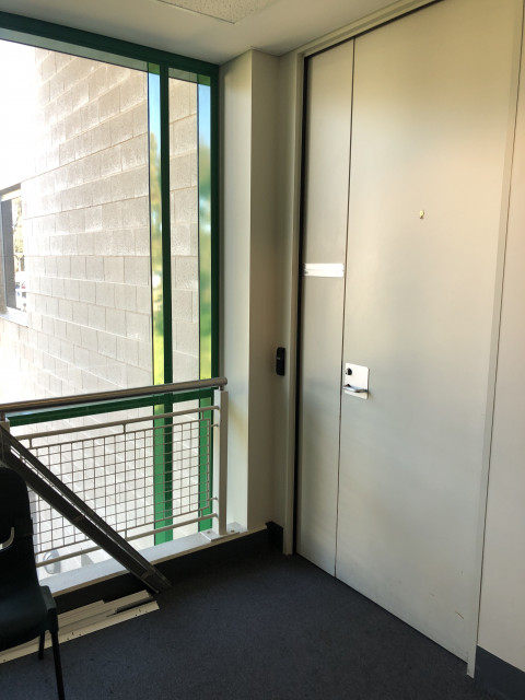 Next to window at top of stairs