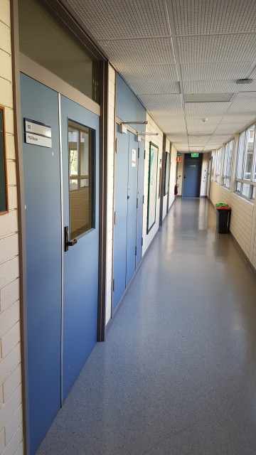 PhD room 125 door 1 facing courtyard entrance.