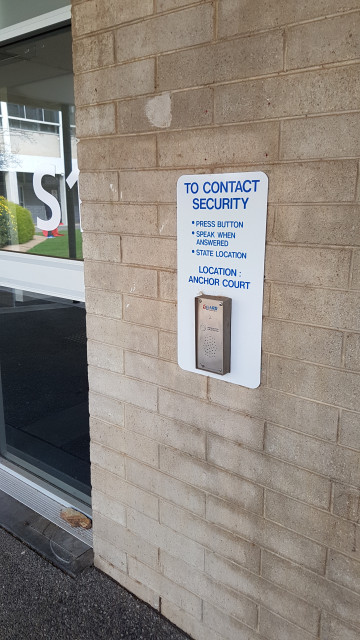 Security intercom panel with clear instructions.