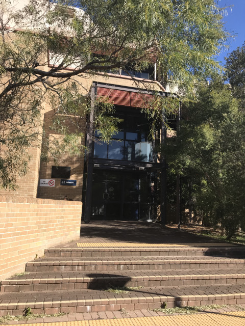 Side entrance, to the right of the main entrance
