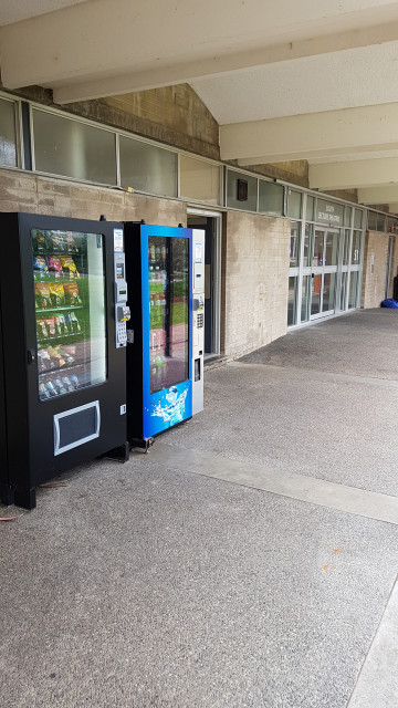 Snack vending machine beside main doors.