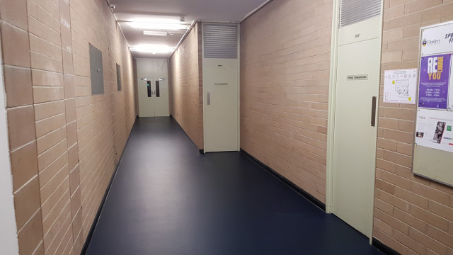 Squash court entrance at end of hallway.