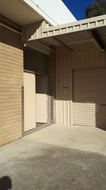 Tennis court entrance, beside storage units