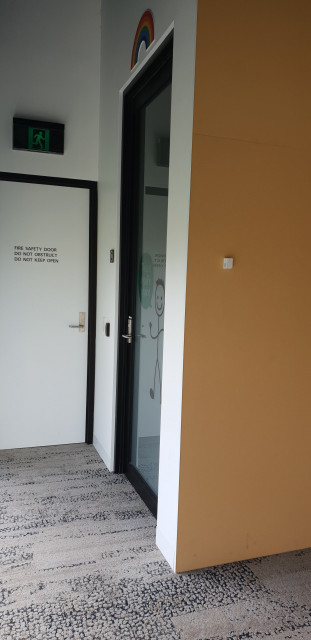 The door to the queer space is tucked away, facing the far windows of the study space