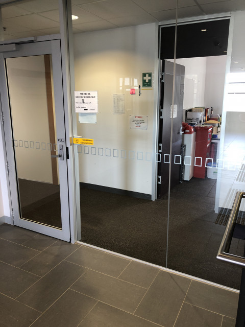 Through door on left, door on right is the office
